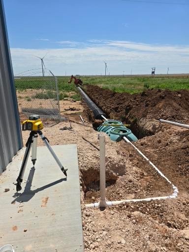 The septic tank installation and utility line trenching by red dirt ditching and septic in Hart TX On solar farm
