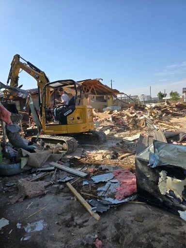 Red Dirt Ditching and Septic excavator demolishing a house in Levelland, Texas