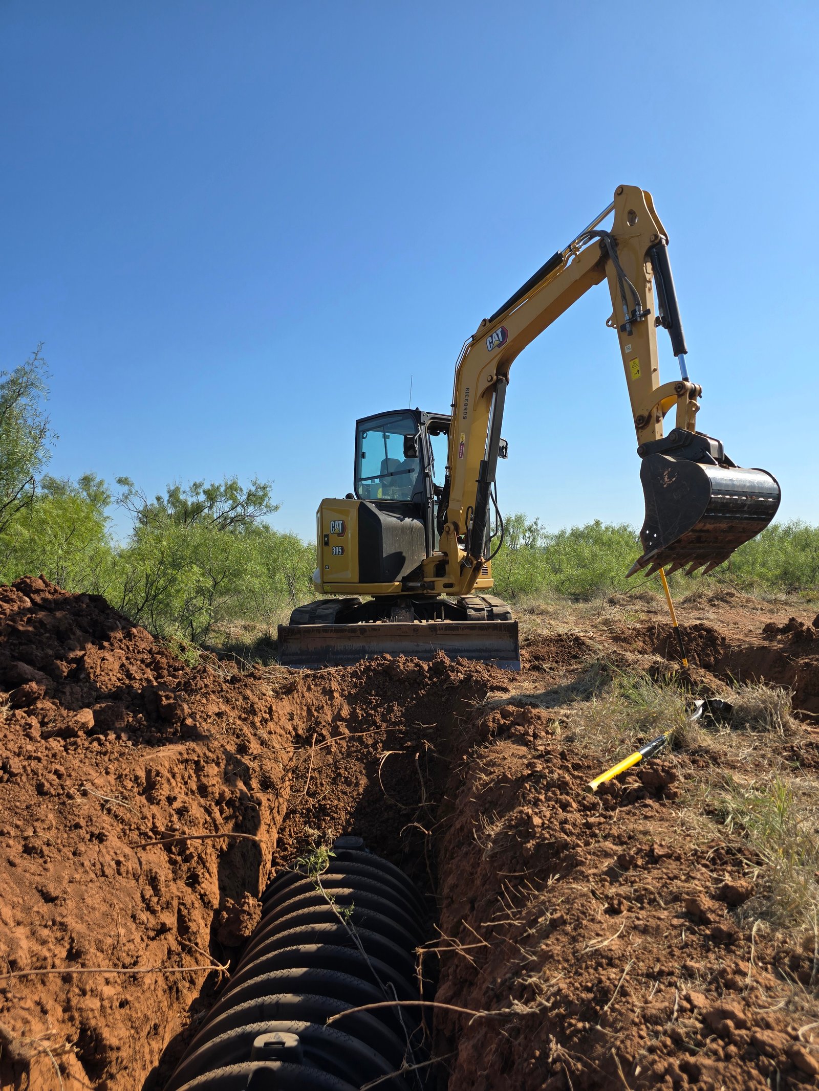 CAT 305 excavator digging a septic trench near Levelland, Texas